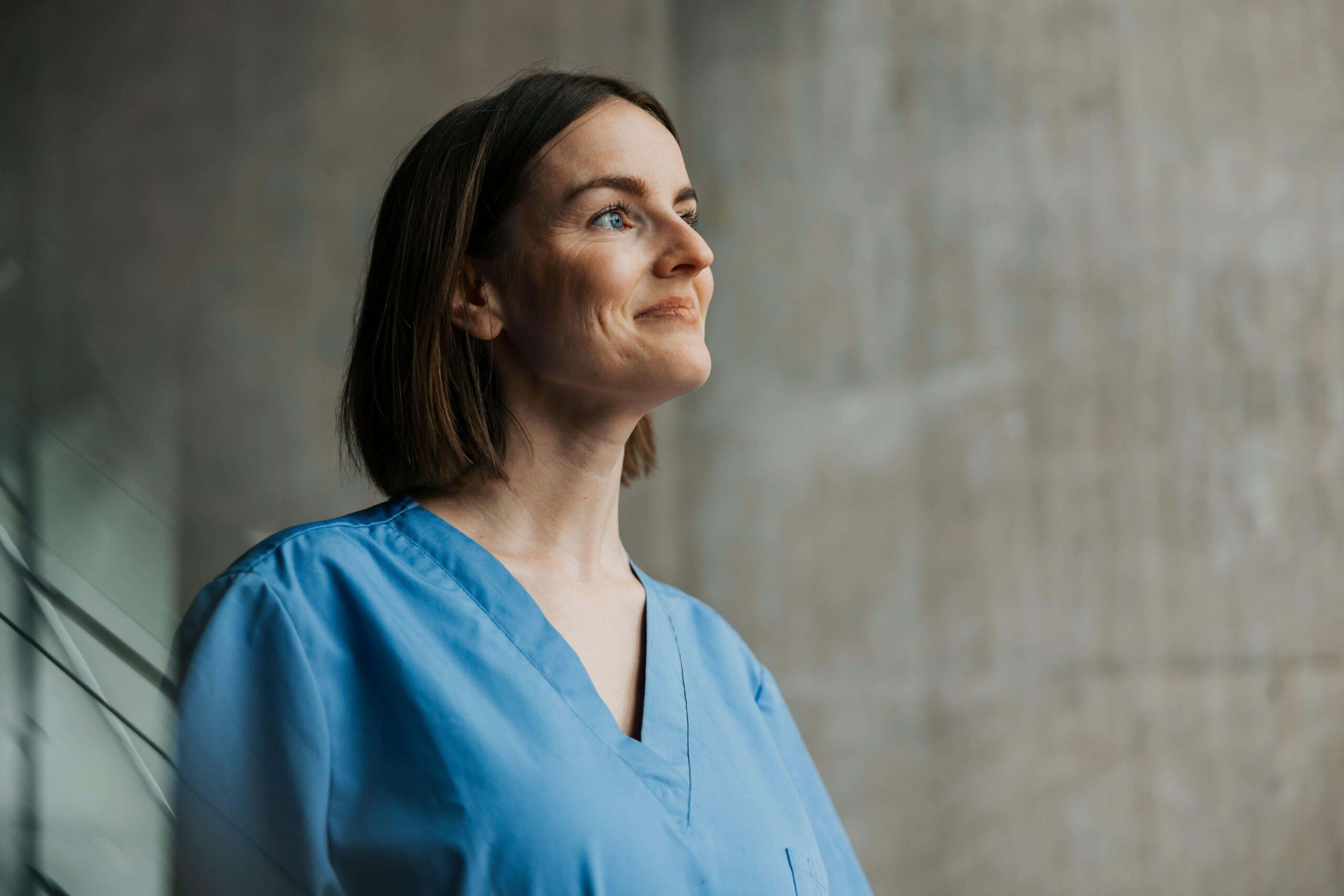 Smiling beautiful female medical professional with short hair looking away